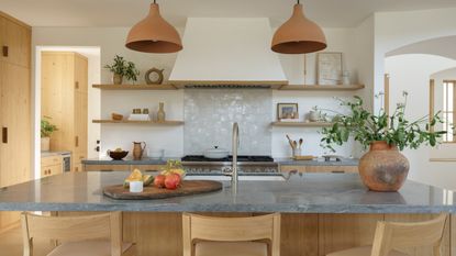A wooden kitchen with neutral tones and zellige tiles