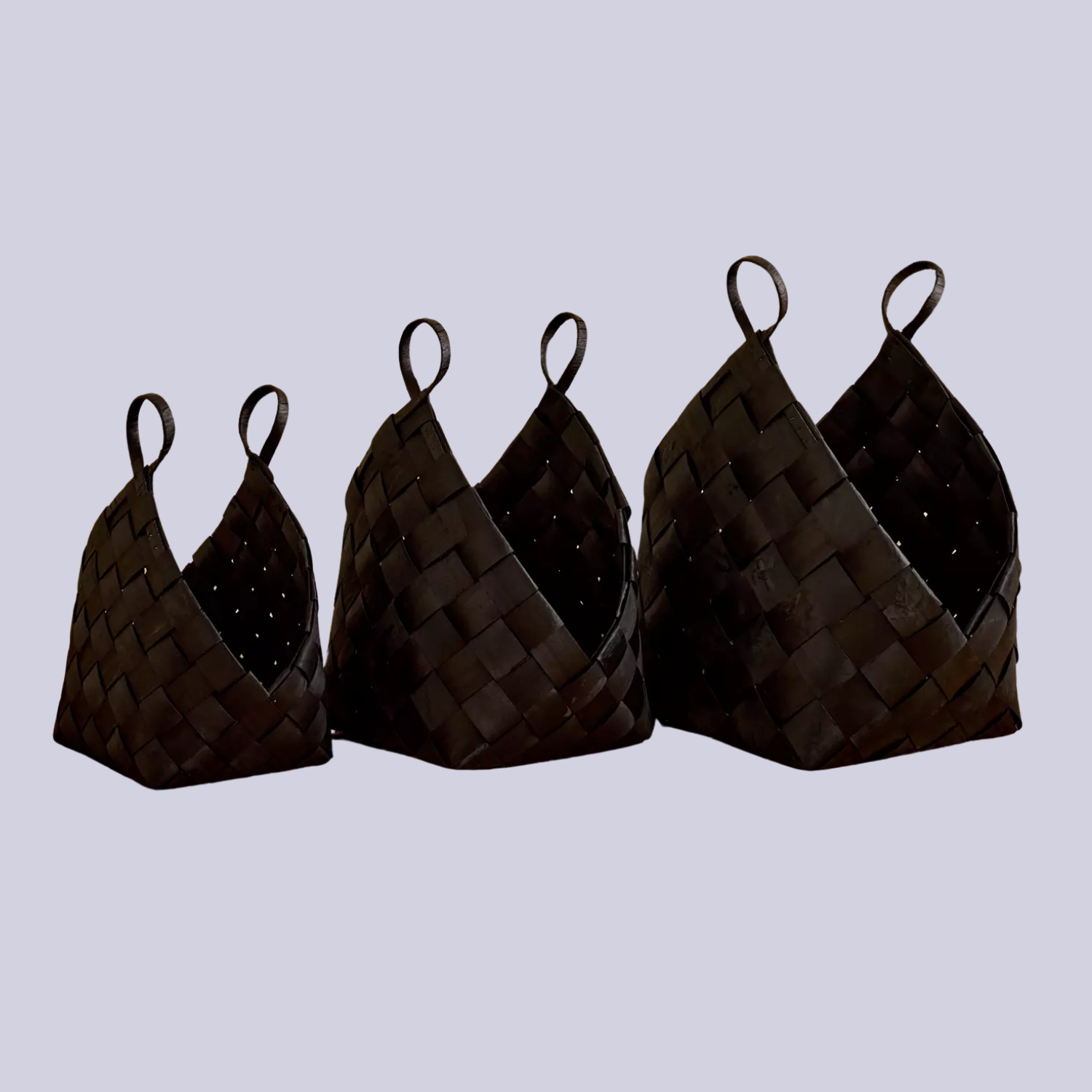 A set of three black woven baskets