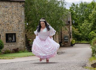 Mandy in her wedding dress walking through the village in Emmerdale 