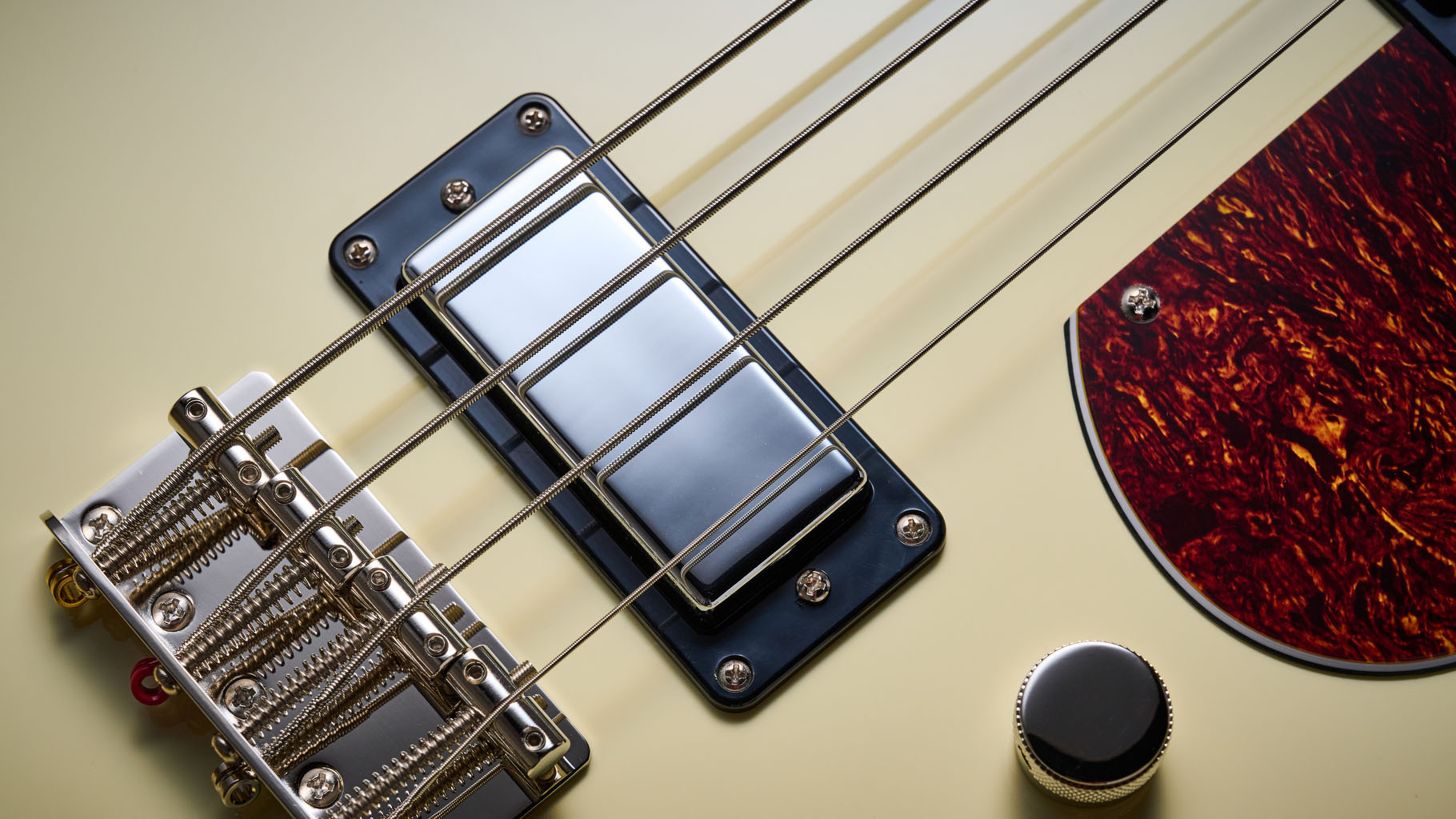 Gretsch Electromatic CVT Bass Double-cut: the retro-styled cream-colored four-string is pictured in close-up against a shaggy brown carpet.