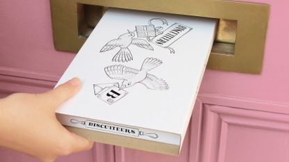 Easter gifts: Biscuiteers package going through pink door letterbox