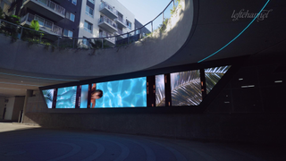 A stunning digital display at a chic LA apartment as guest pull in the circular driveway.