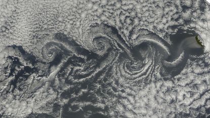 Satellite image of cloud vortices swirling behind islands in the Atlantic Ocean