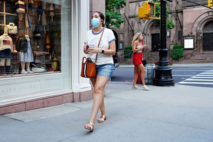 A woman wears a mask in New York City.