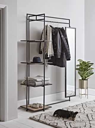 black metal hanging rail with shelving and mirror