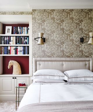 Bedroom with textured gold wallpaper and fitted bookcase with red wall.jpg