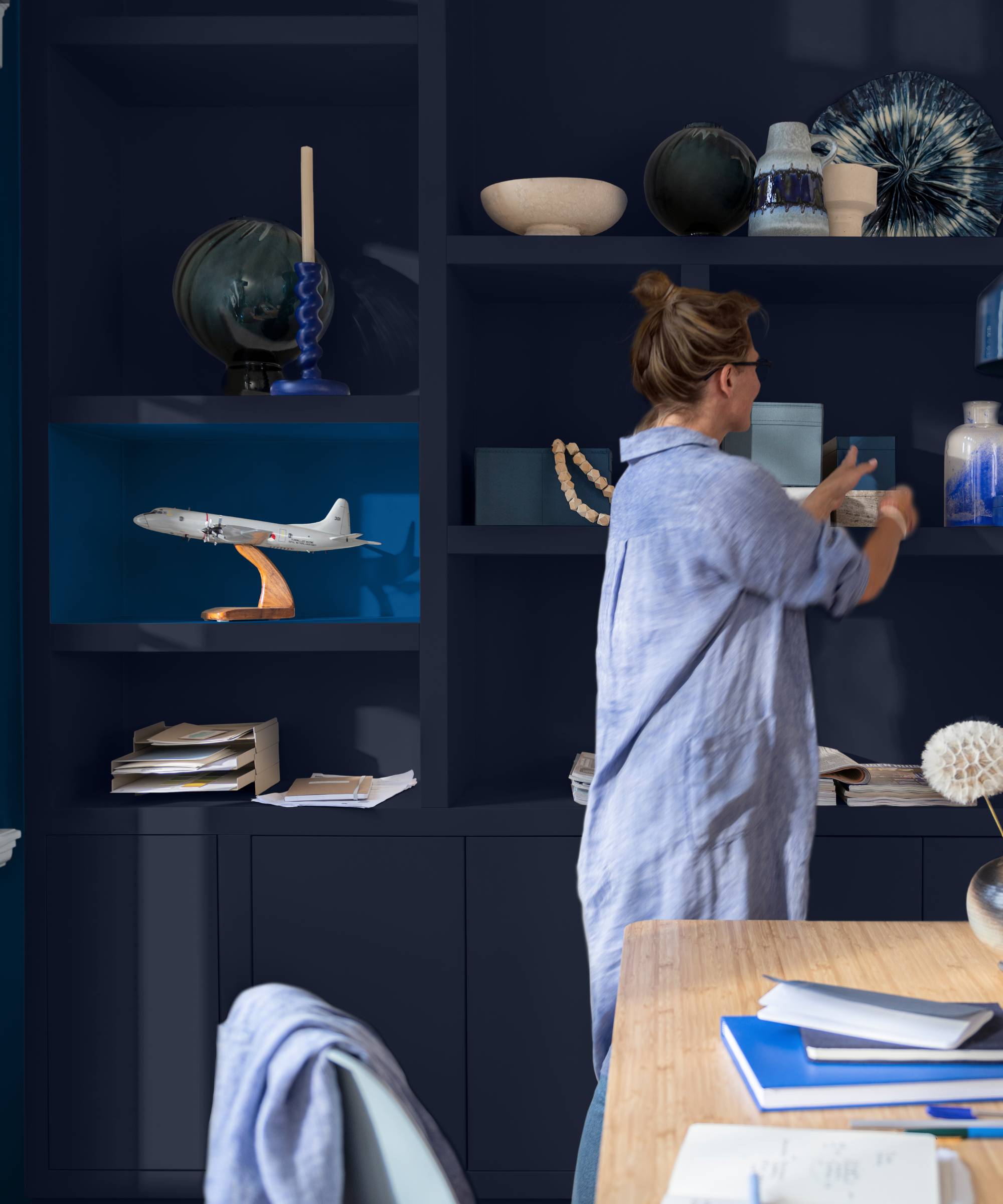 built in alcove shelving in dark blue with one bright blue section