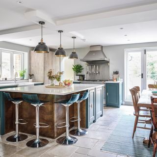 kitchen diner in a modern country style with metal bar stools around island