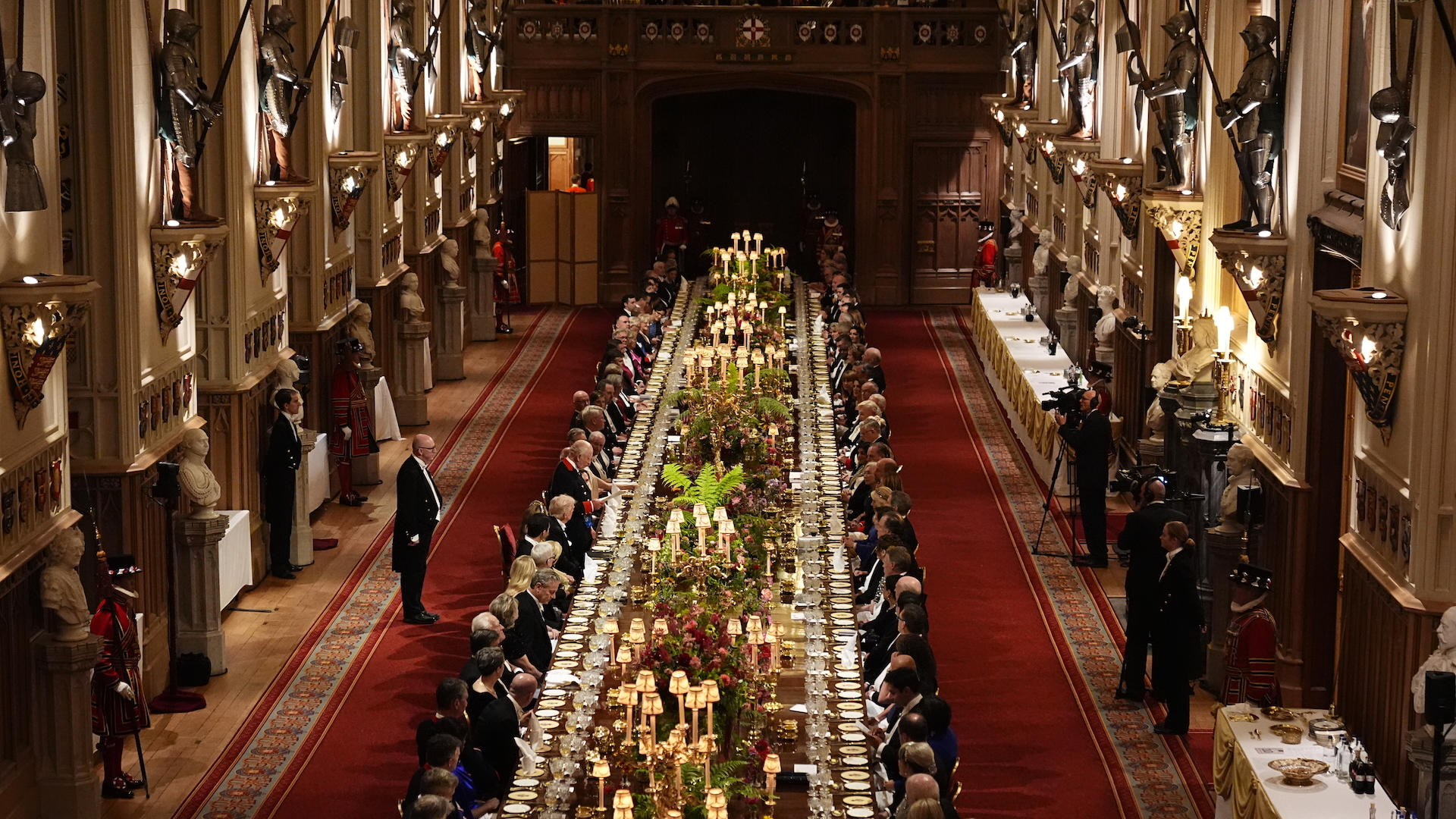 A wide shot shows King Charles III standing to give a speech at the State Banquet hosted by King Charles III and members of the Royal Family at Windsor Castle on 17 September 2025