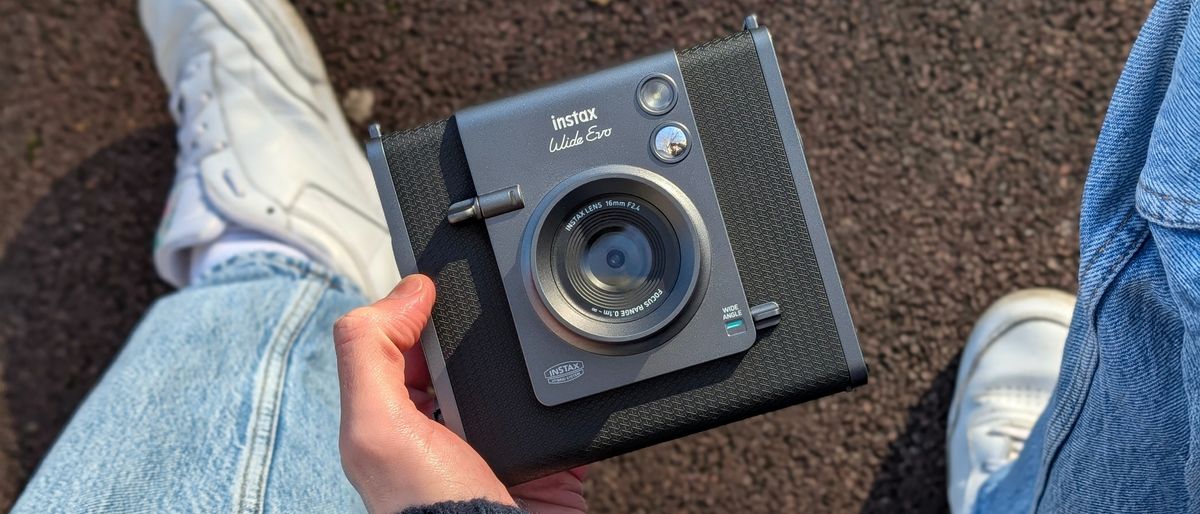 Fujifilm Instax Wide Evo held in a hand outside