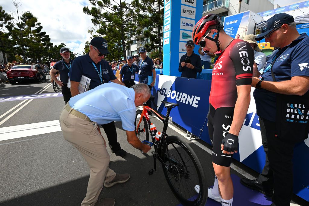 UCI commissaires performing a technical bike control to the bike of Leo Hayter (Ineos Grenadiers) prior to the start