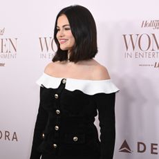 Selena Gomez walks the Hollywood Reporter Women in Hollywood red carpet wearing an off the shoulder dress with Manolo Blahnik Mary Janes