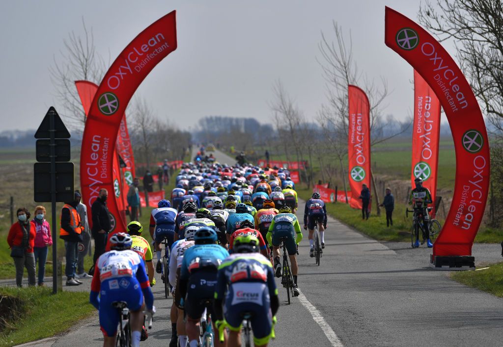 DE PANNE BELGIUM MARCH 24 The Peloton during the 45th Oxyclean Brugge De Panne 2021 Men Classic a 2039km race from Brugge to De Panne Fans Public Landscape OxycleanClassic on March 24 2021 in De Panne Belgium Photo by Luc ClaessenGetty Images