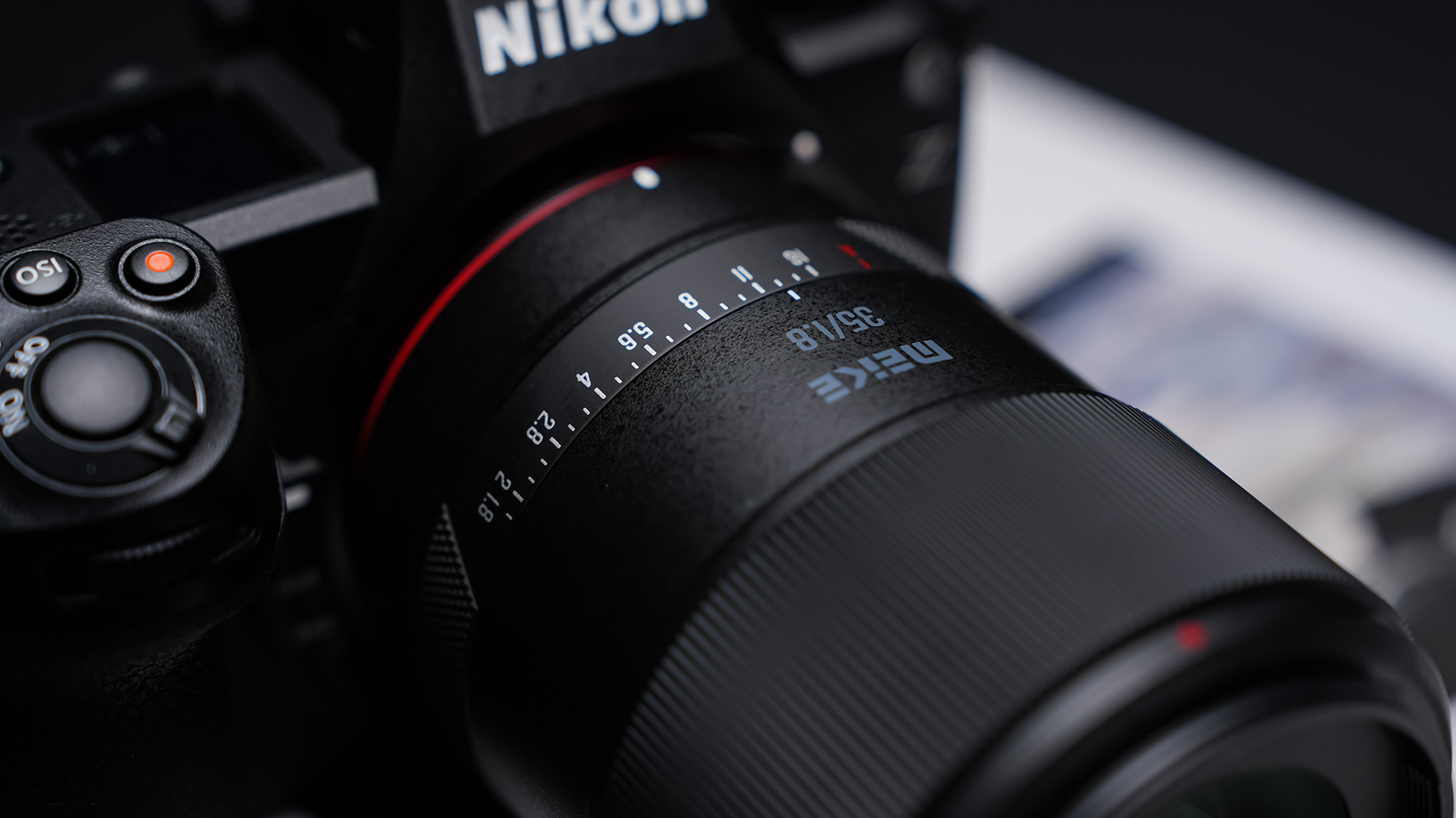 Meike 35mm f/1.8 Pro attached to a Nikon Z Camera, resting on a photo book