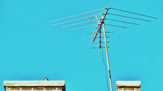 A television antenna against a blue sky