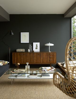 Dark grey living room with rattan swinging chair