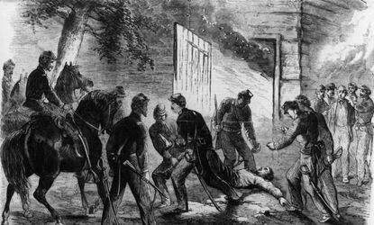 John Wilkes Booth is dragged from the barn on Garretts farm by Union cavalry.