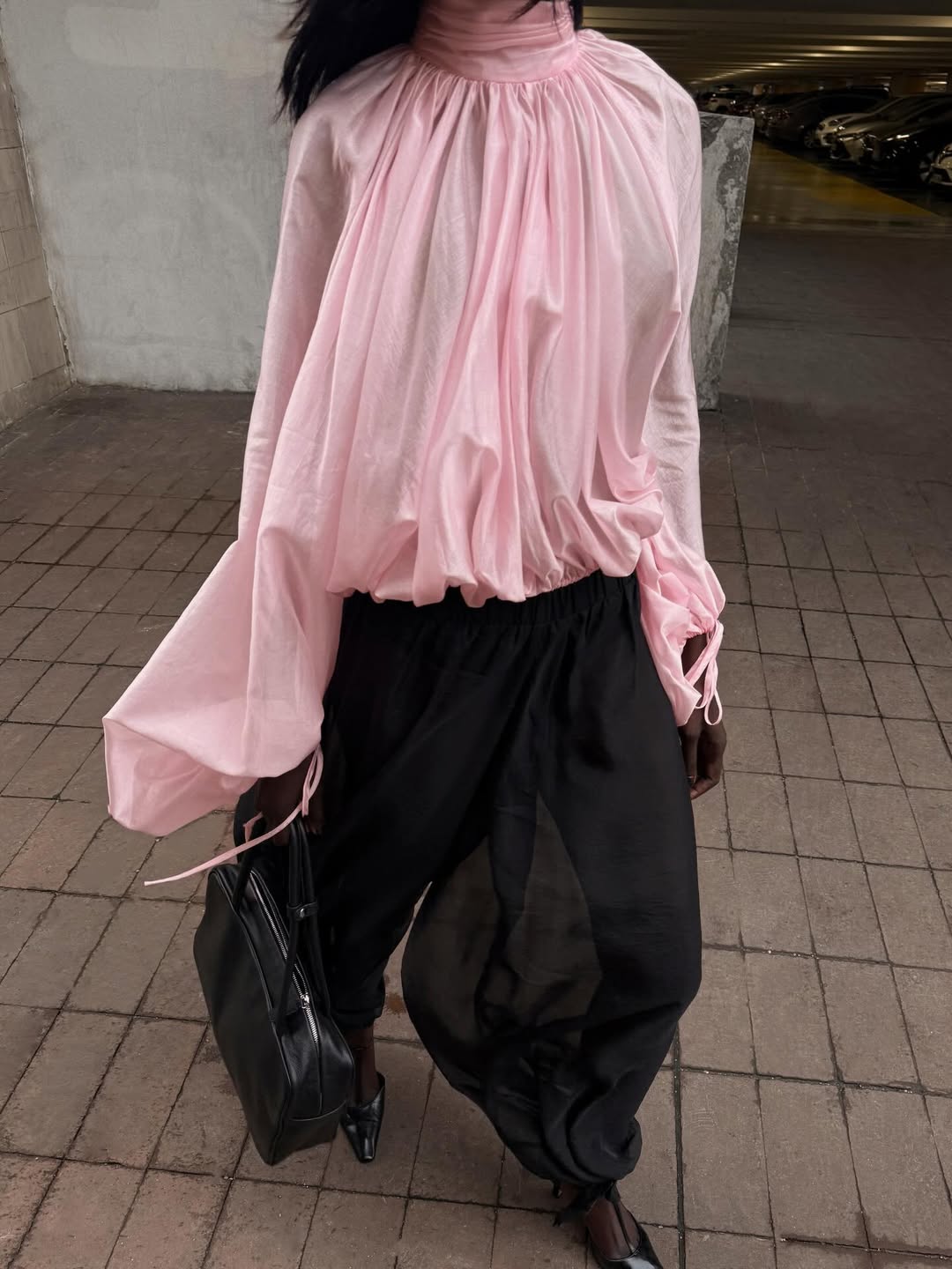 Amy in a flowy pink blouse