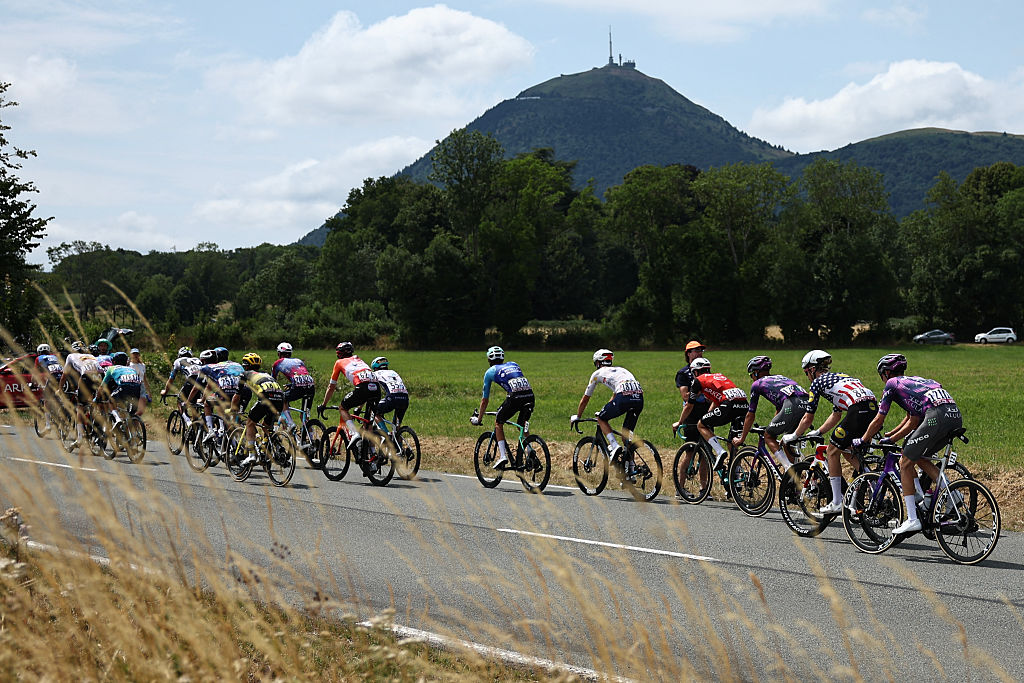The breakaway group cycles near the Puy de Dome during the 10th stage of the 112th edition of the Tour de France cycling race, 165.3 km between Ennezat and Le Mont-Dore Puy de Sancy, in central France, on July 14, 2025. (Photo by Anne-Christine POUJOULAT / AFP)