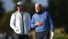 Rory and Gerry McIlroy walk on the green