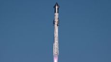 closeup of a huge silver rocket flying through a blue sky