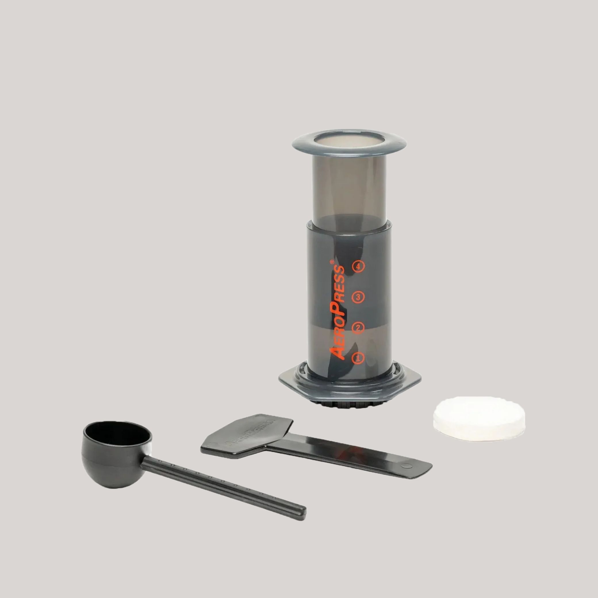 Aeropress Coffee Brewer against pale gray background.