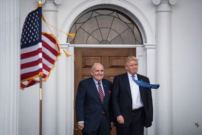 Donald Trump greets Rudy Giuliani at the clubhouse at Trump National Golf Club Bedminster