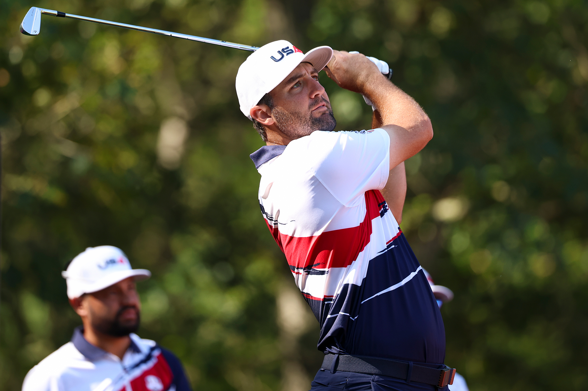 Scottie Scheffler in the finish position with an iron during a practice round at the 2025 Ryder Cup