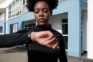 Training tips for a marathon: Woman checking her fitness watch