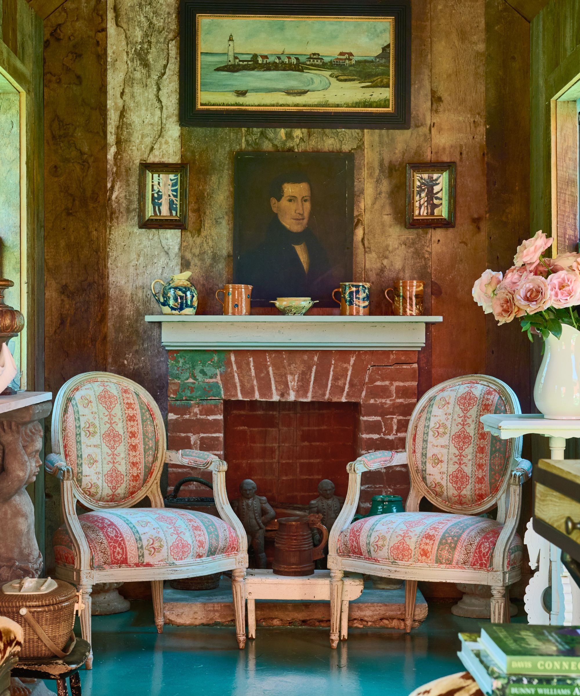 Sitting room with antique chairs and brick fireplace