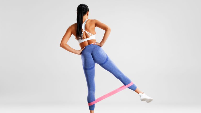 a photo of a woman doing a resistance band glute exercise 