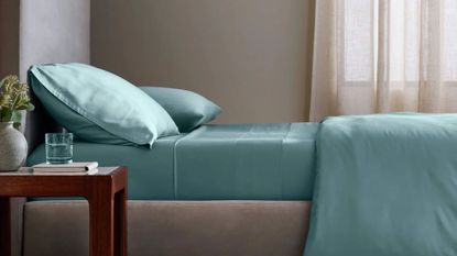 A bedroom with blue bamboo bedding