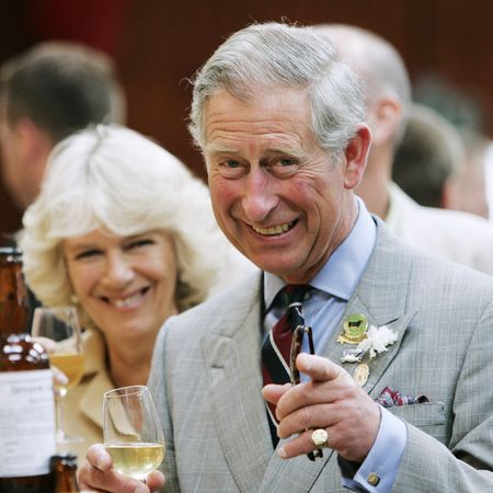 Queen Camilla and King Charles smile while sampling some wine and beers