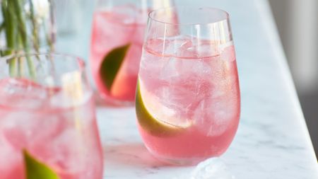 a pink cocktail on a marble worktop