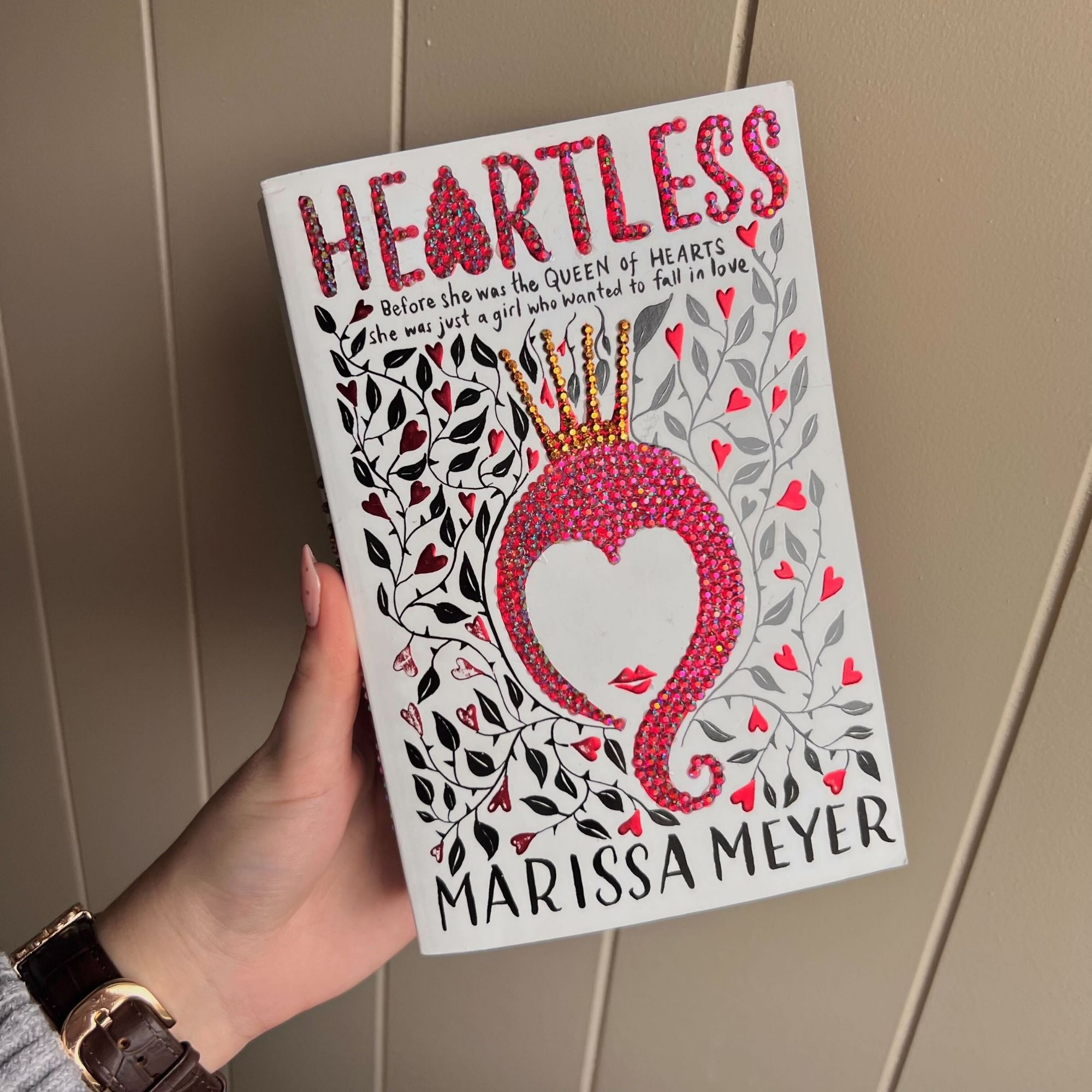 Layla Al-Ani holding the book she bedazzled.