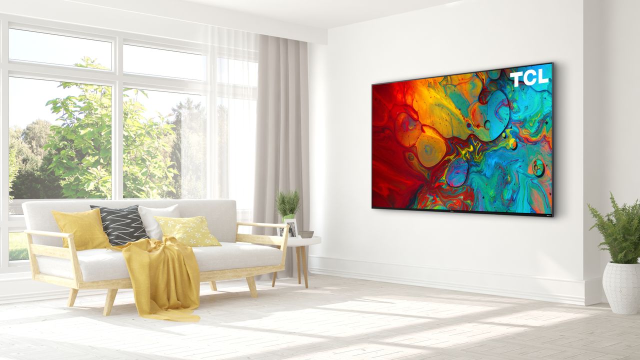 The 2022 TCL R655 hanging on a wall in a living room.