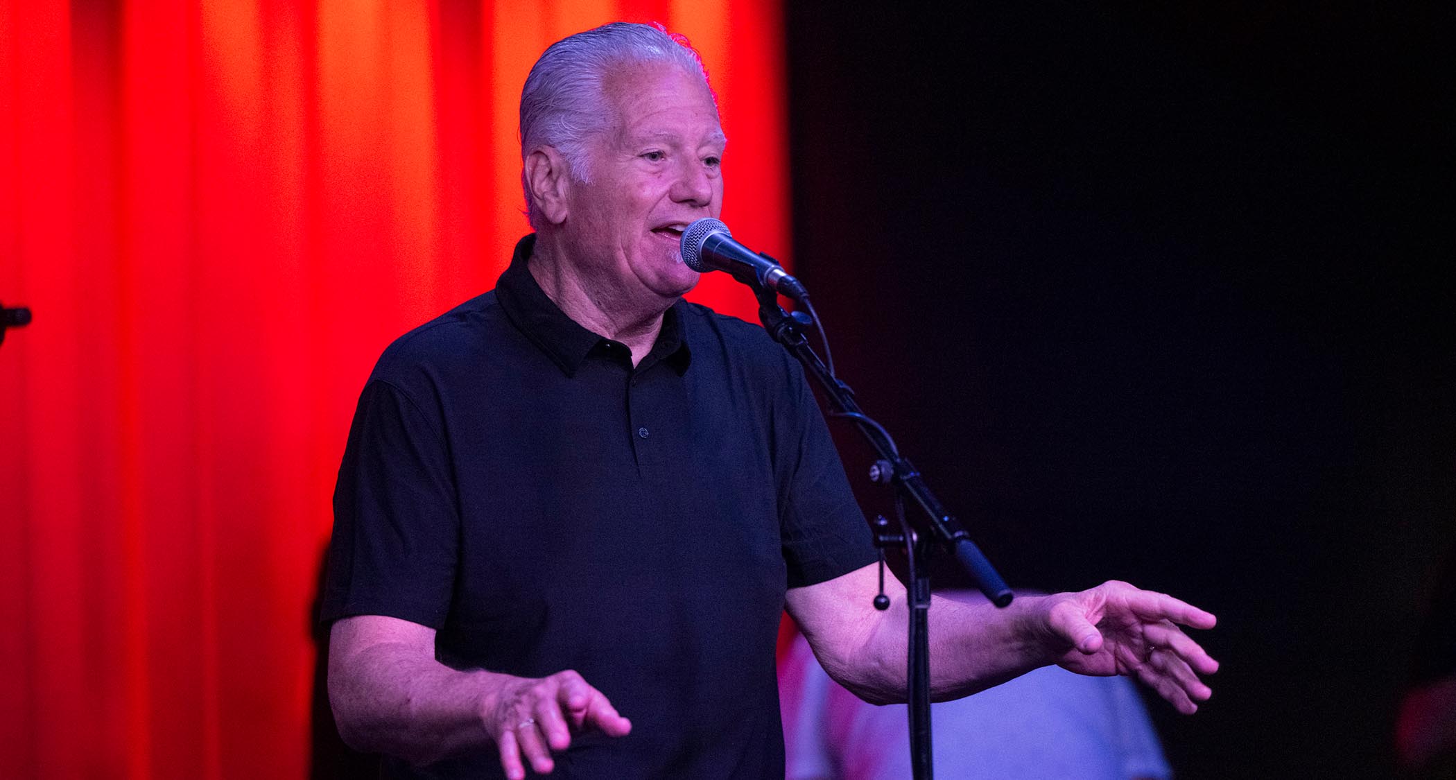 Norman Harris of Norman's Rare Guitars gives a talk onstage.