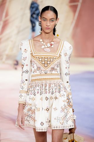 A model wearing a seashell necklace and shell earrings in Ulla Johnson Spring 2020 show