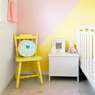 childrens room with yellow chair and white vanity