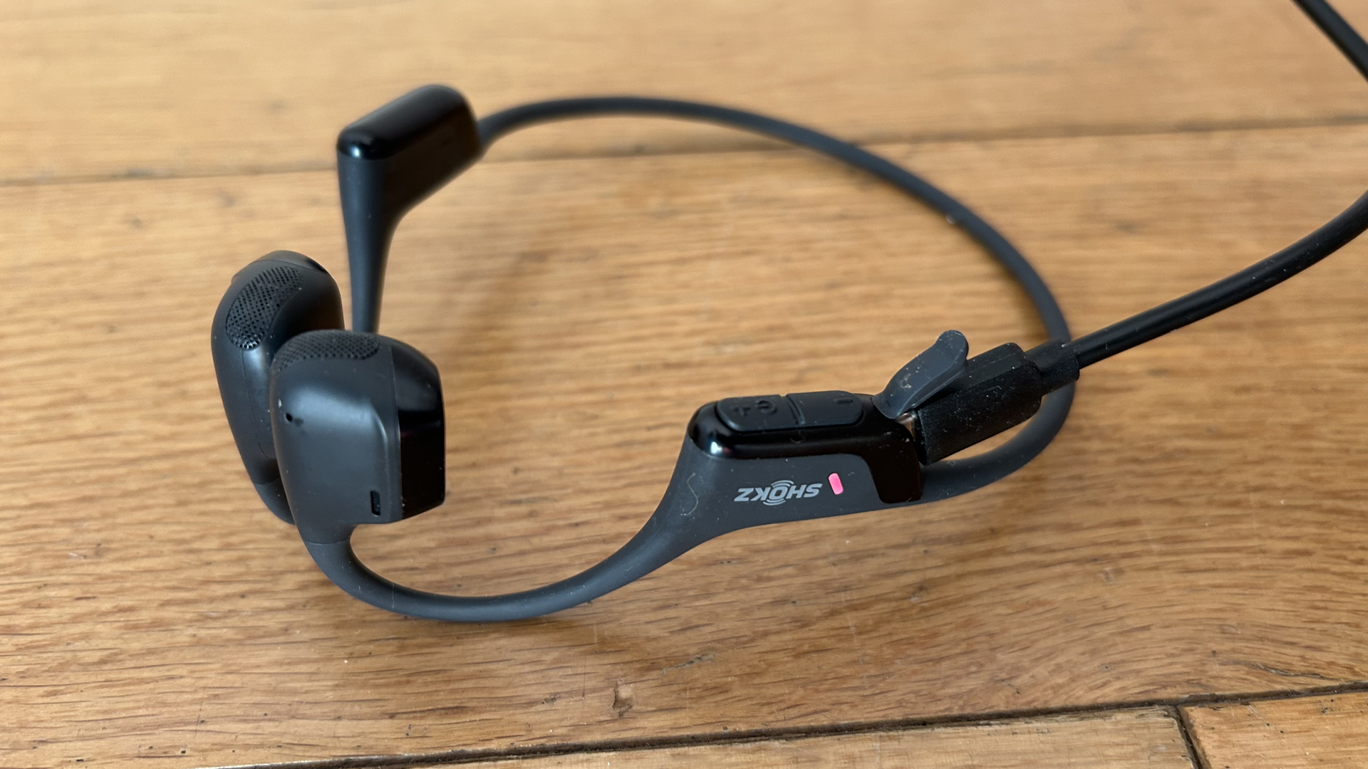 The Shokz OpenRun Pro 2 headphones charging