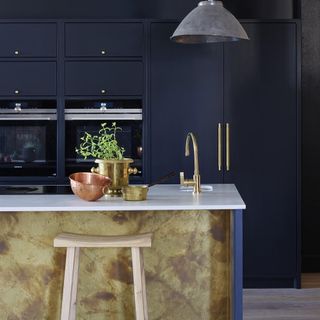 Navy blue kitchen with gold kitchen island