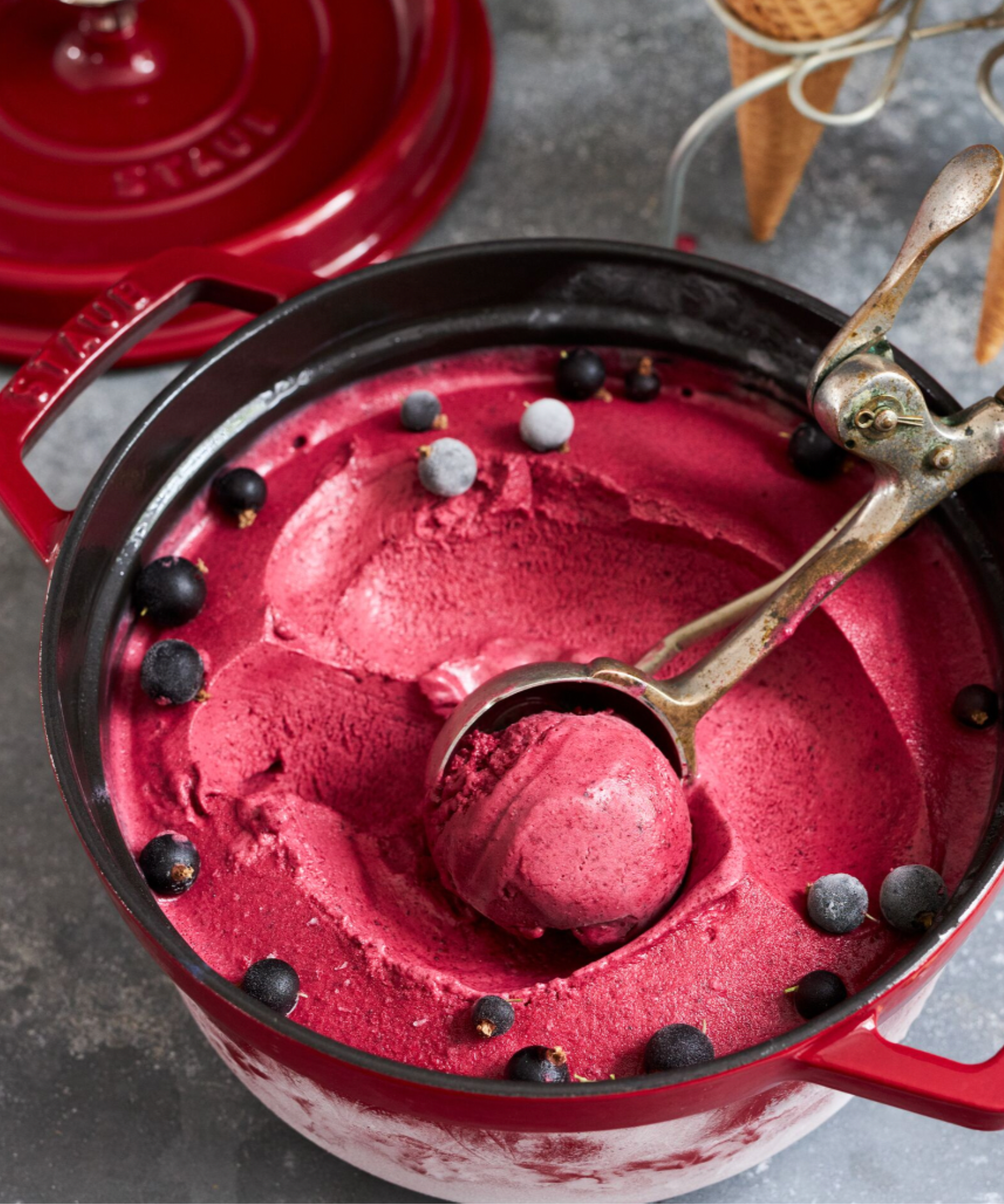 Staub Cast Iron Cocotte in grenadine, holding berry sorbet