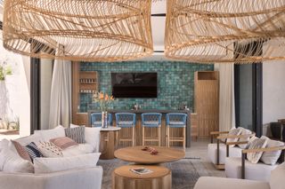 a home bar with a tiled wall and TV