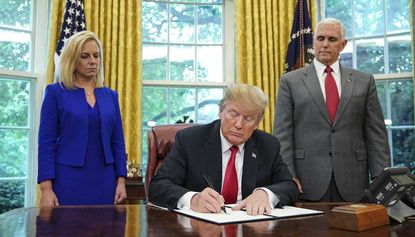 Donald Trump signs an executive order reversing family separation policy