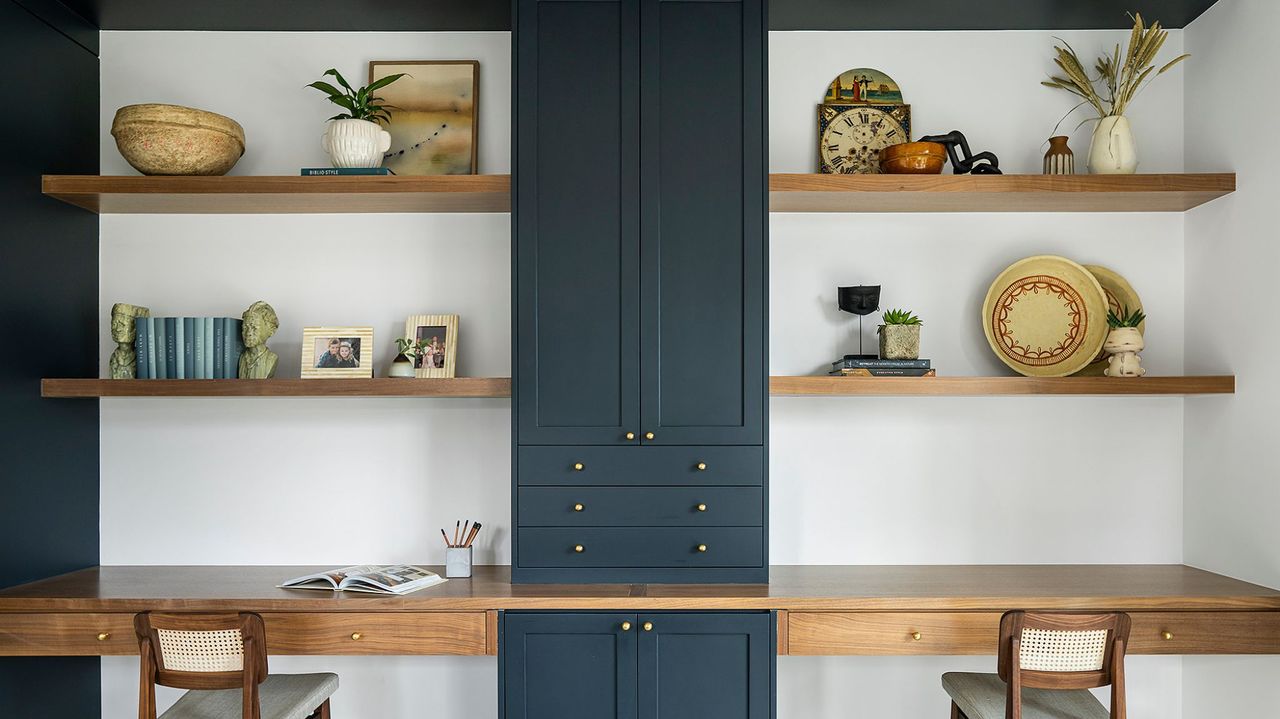 home office with blue open shelves styled with various items