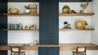 home office with blue open shelves styled with various items
