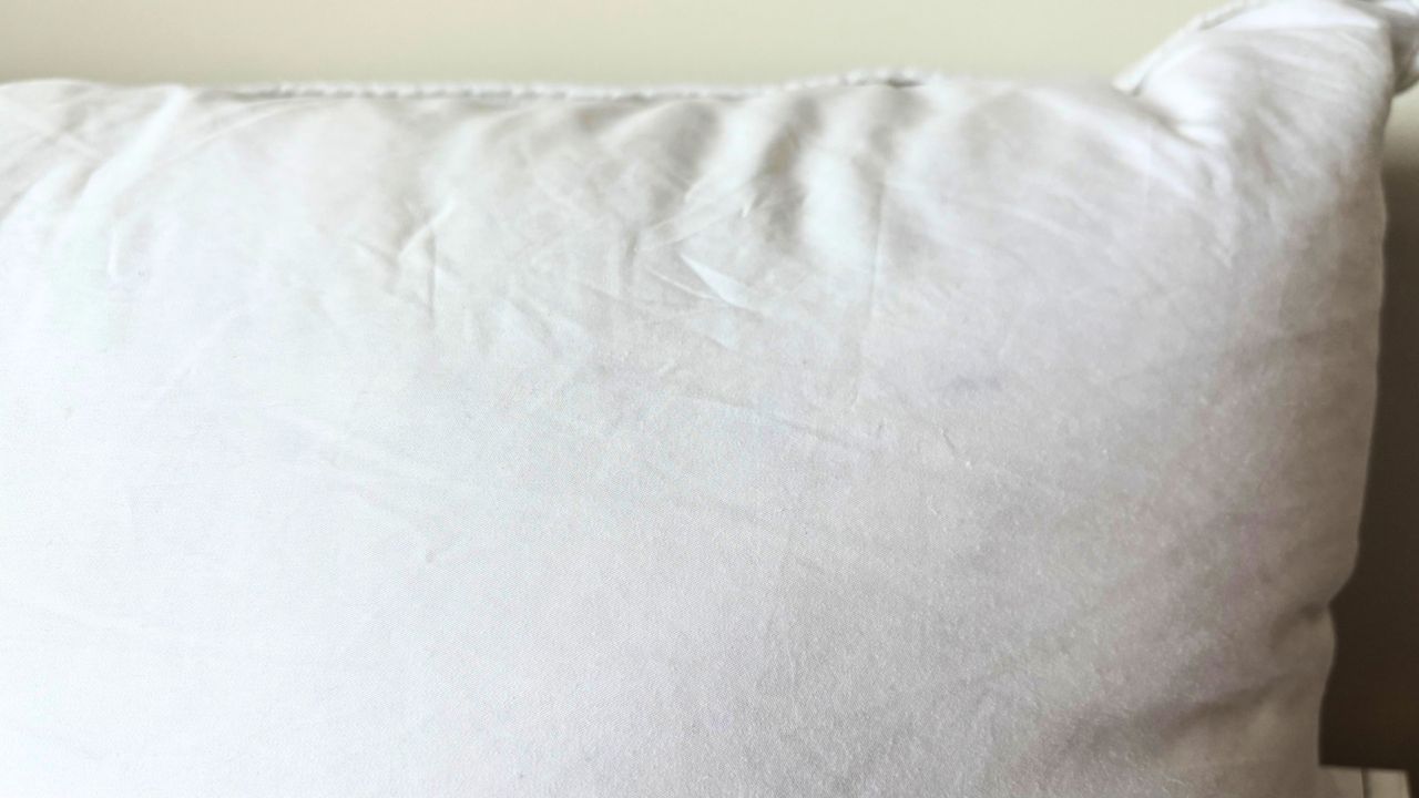 A pillow with its yellow retinol stain lifted after a hydrogen peroxide treatment.