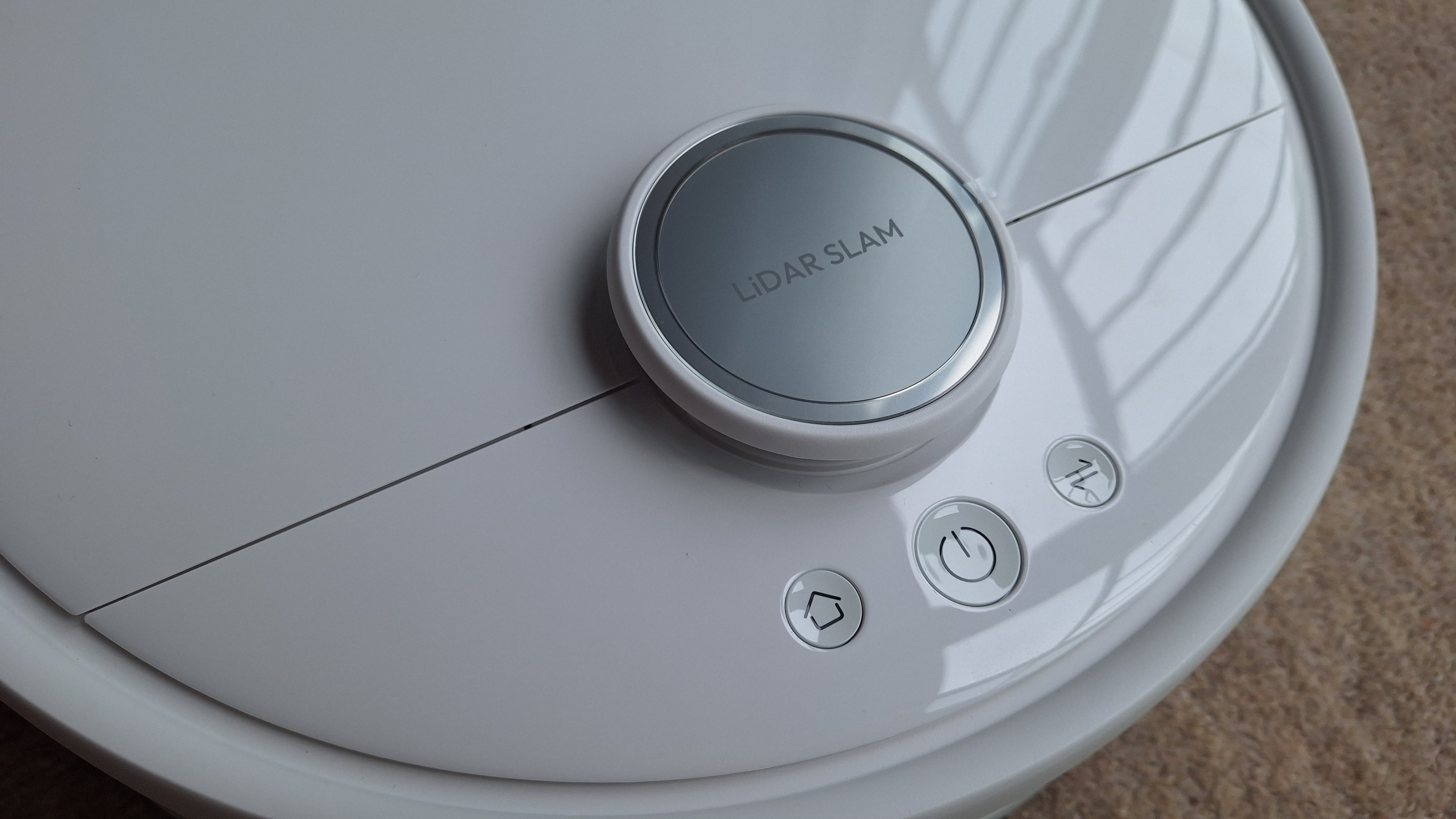 Close-up of top of SwitchBot S20 robot vacuum, with buttons and LiDAR puck