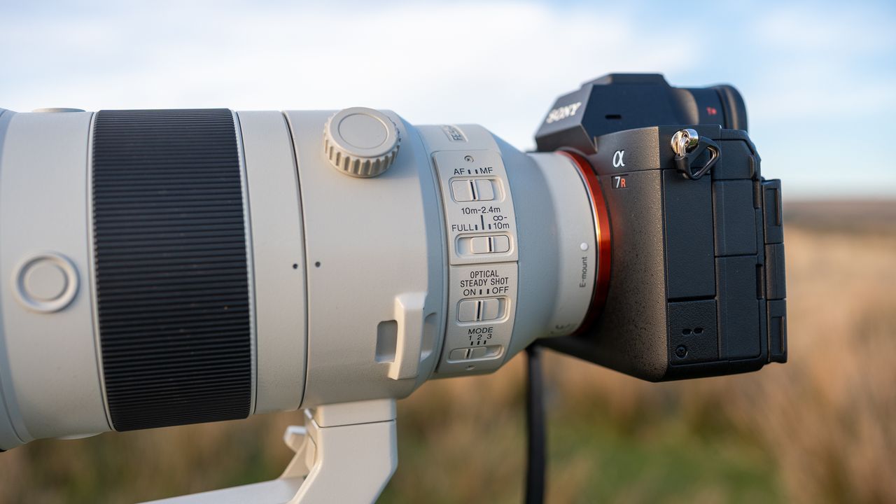 Sony FE 200-600 f/5.6-6.3 G OSS and Sony camera on a tripod in a field