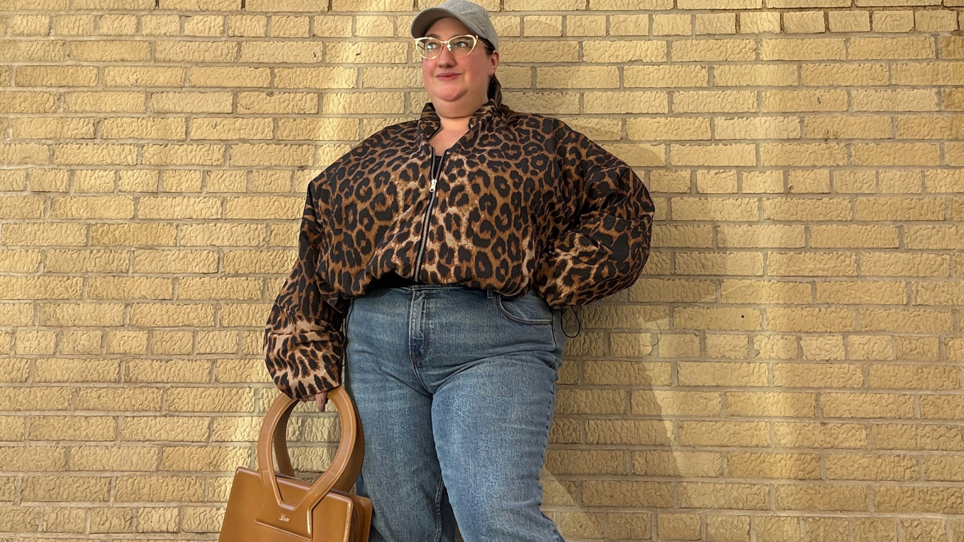 Sarah Chiwaya wearing a leopard print bomber and straight leg jeans